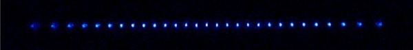 A chain of Th atoms suspended in an RF ion trap.